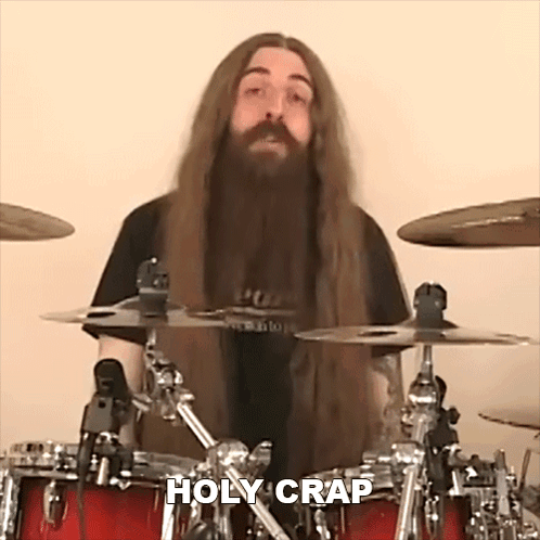 Man With Long Hair And Beard Playing Drums Saying Holy Crap GIF
