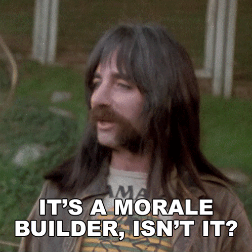 A Man With Long Hair And A Beard Is Saying It 'S A Morale Builder Isn 'T It GIF
