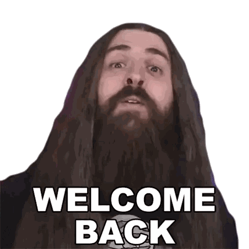 a man with long hair and a beard is saying " welcome back "