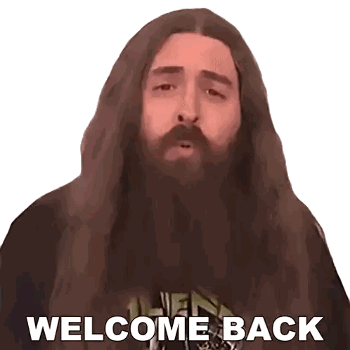 a man with long hair and a beard is saying " welcome back "