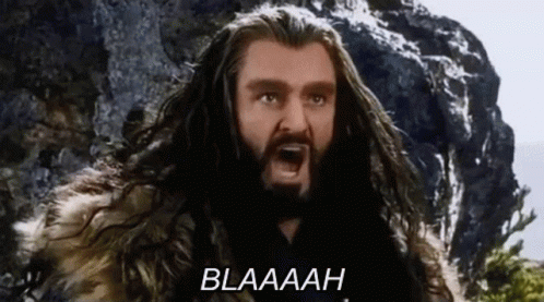 A Man With Long Hair And A Beard Is Screaming With The Word Blaaah Written Below Him . GIF