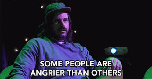 A Man With Long Hair And A Beard Is Sitting In Front Of A Projector And Says " Some People Are Angrier Than Others " GIF