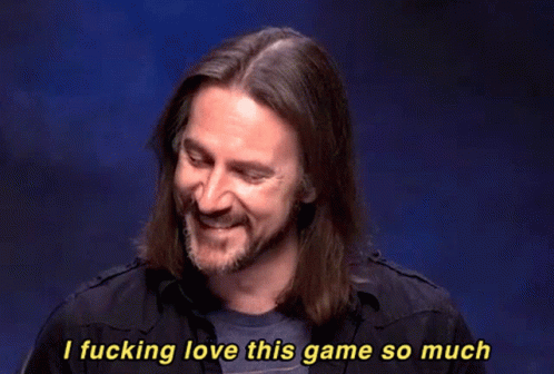 A Man With Long Hair And A Beard Is Smiling And Saying " I Fucking Love This Game So Much " GIF
