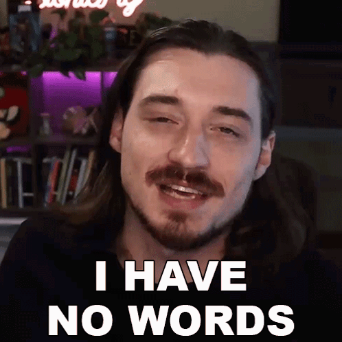 A Man With Long Hair And A Beard Is Smiling And Saying I Have No Words GIF