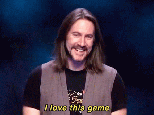 A Man With Long Hair And A Beard Is Smiling And Saying I Love This Game GIF