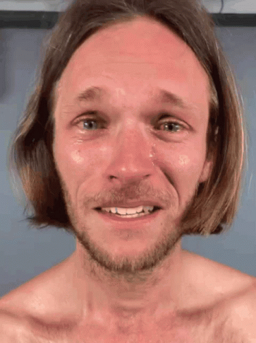 A Man With Long Hair And A Beard Is Smiling With Tears Coming Out Of His Eyes GIF