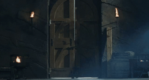A Man With Long Hair And A Beard Is Standing In A Dark Room With His Arms Outstretched GIF