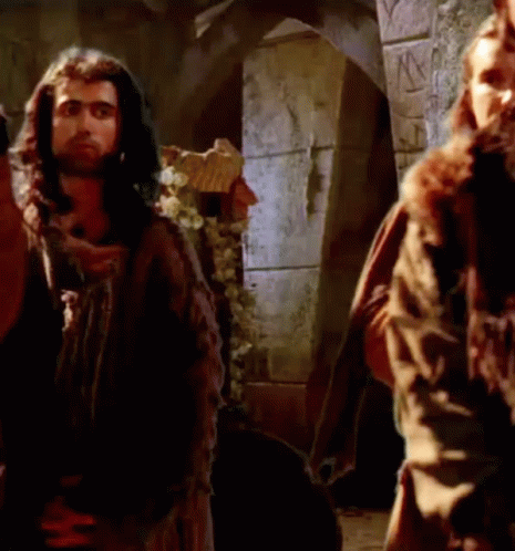 Man With Long Hair And Beard Next To Another Man In Castle GIF