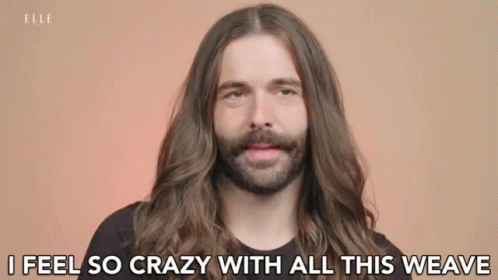 A Man With Long Hair And A Beard Is Talking About His Hair . GIF