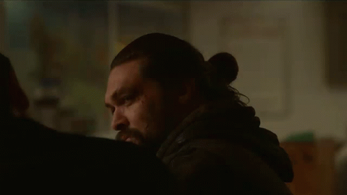 A Man With Long Hair And A Beard Is Talking To Another Man . GIF