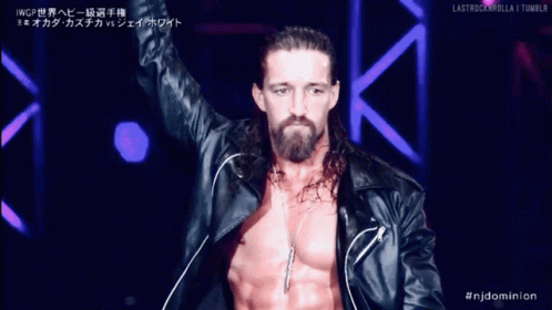 a man with long hair and a beard is wearing a black leather jacket and necklace