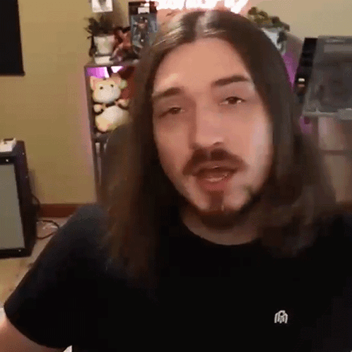 Man With Long Hair And Beard Wearing Black Shirt With Chinese Symbol GIF