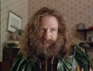 A Man With Long Hair And A Beard Is Wearing A Green Leafy Outfit . GIF