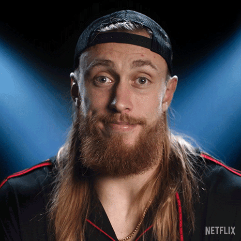 A Man With Long Hair And A Beard Is Wearing A Hat And A Shirt That Says Netflix GIF
