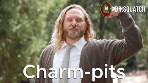 A Man With Long Hair And A Beard Is Wearing A Sweater And Tie With The Words Charm-Pits On The Bottom GIF