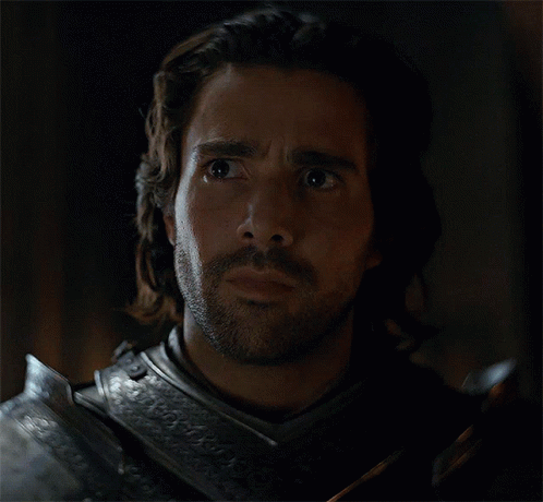 A Man With Long Hair And A Beard Is Wearing Armor And Looking Surprised GIF