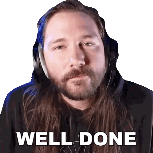a man with long hair and a beard is wearing headphones and says " well done "