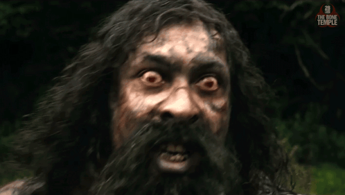 a man with long hair and a beard looks at the camera with the bone temple written on the bottom right