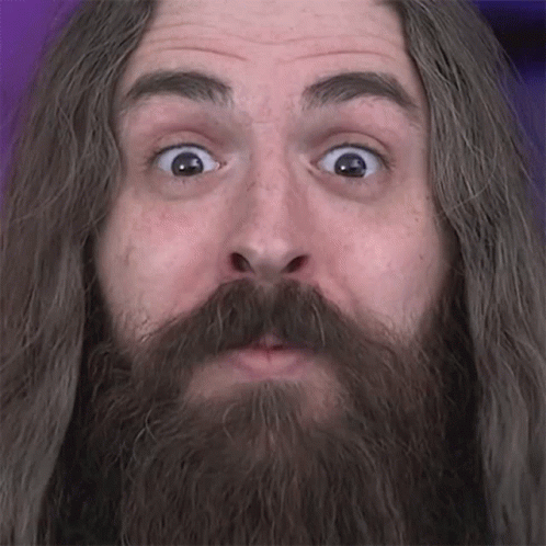 A Man With Long Hair And A Beard Looks Surprised GIF