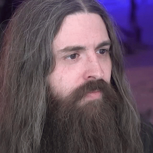 Man With Long Hair And Beard Looking Left GIF