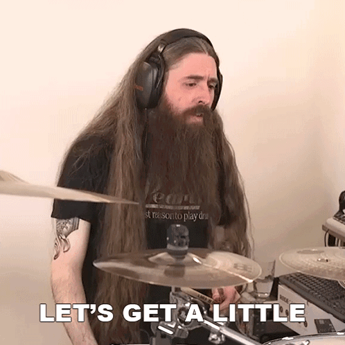 A Man With Long Hair And A Beard Playing Drums With The Words Let 'S Get A Little Behind Him GIF
