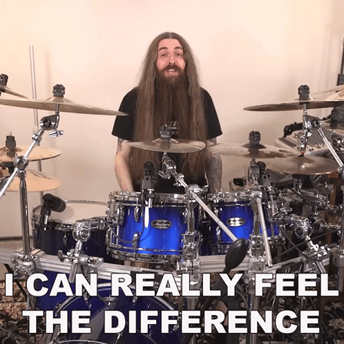 Man With Long Hair And Beard Playing Drums GIF