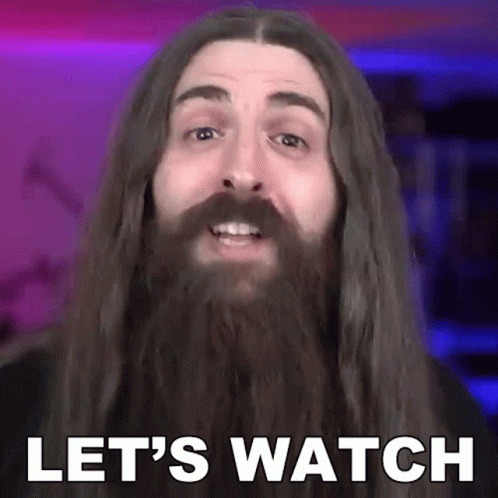 A Man With Long Hair And A Beard Saying Let 'S Watch GIF