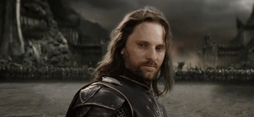 A Man With Long Hair And A Beard Says " Yolo " In White Letters GIF