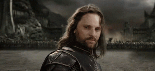 A Man With Long Hair And A Beard Says " Yolo " In White Letters GIF