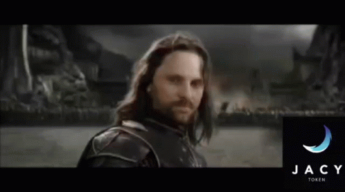A Man With Long Hair And A Beard Stands In Front Of The Jacy Family Logo GIF