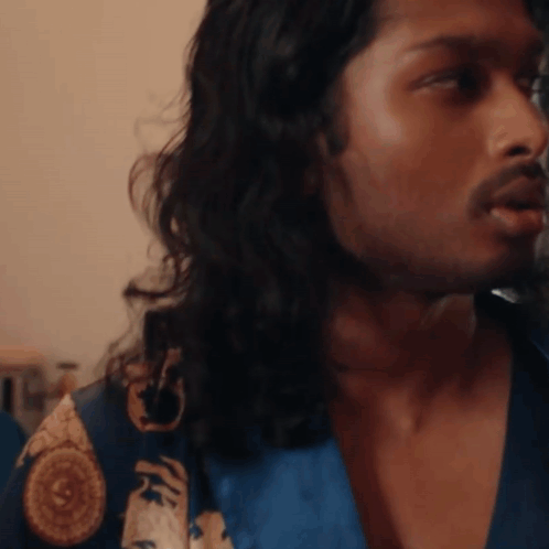 A Man With Long Hair And A Beard Wearing A Blue Robe GIF