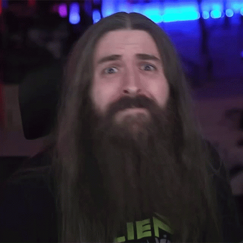 A Man With Long Hair And A Beard Wearing A Shirt That Says Alien GIF