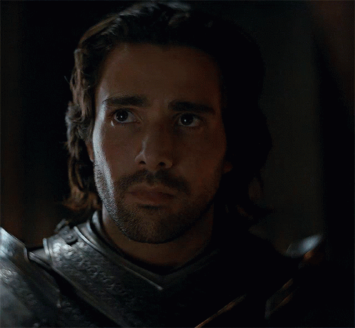 A Man With Long Hair And A Beard Wearing Armor GIF