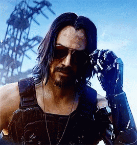 A Man With Long Hair And A Beard Wearing Sunglasses And A Robotic Arm . GIF