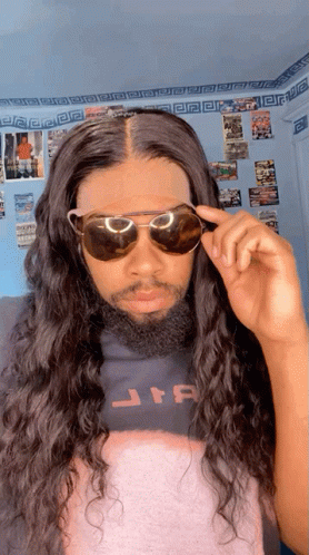 A Man With Long Hair And A Beard Wearing Sunglasses And A Star Wars Shirt GIF