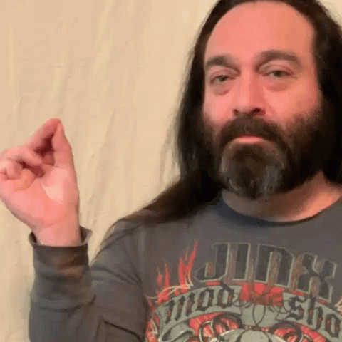 A Man With Long Hair And A Beard Wears A Shirt That Says Jinx On It GIF