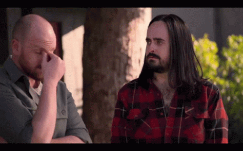 Man With Long Hair And Beard Wipes Nose GIF