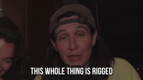 A Man With Long Hair And A Hat Is Saying This Whole Thing Is Rigged GIF