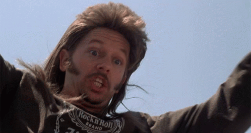 A Man With Long Hair And A Rock N Roll Shirt On GIF
