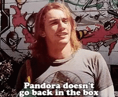 A Man With Long Hair And A T-Shirt That Says Pandora Does N't Go Back In The Box . GIF