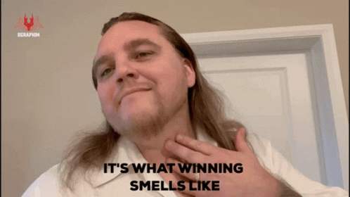 A Man With Long Hair And A White Shirt Says " It 'S What Winning Smells Like " GIF