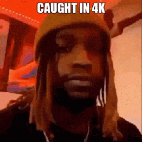 A Man With Long Hair And Dreadlocks Is Wearing A Yellow Hat And A Mask . GIF