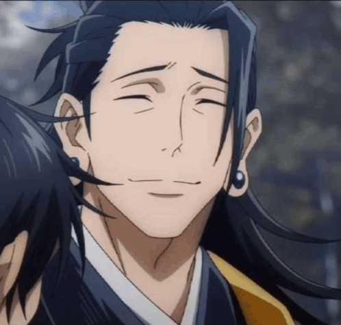 A Man With Long Hair And Earrings Is Smiling And Looking At The Camera . GIF