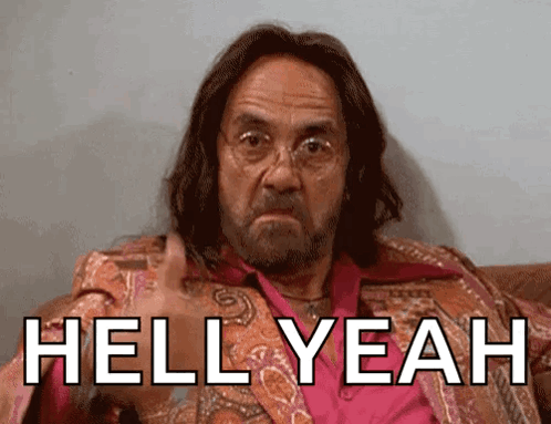 A Man With Long Hair And Glasses Is Sitting On A Couch With The Words Hell Yeah Above Him GIF