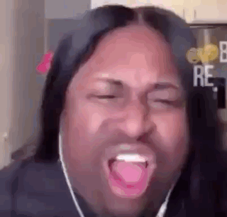 A Man With Long Hair And Headphones Is Making A Funny Face With His Mouth Open . GIF