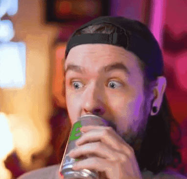 A Man With Long Hair Is Drinking From A Can . GIF