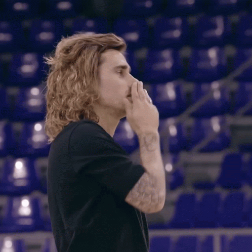 A Man With Long Hair Is Giving A Thumbs Up GIF