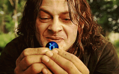 A Man With Long Hair Is Holding A Blue Ball With A Letter O On It GIF