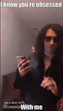 A Man With Long Hair Is Holding A Cell Phone With A Caption That Says I Know You 'Re Obsessed GIF