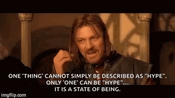 A Man With Long Hair Is Making A Funny Face While Talking About A State Of Being . GIF